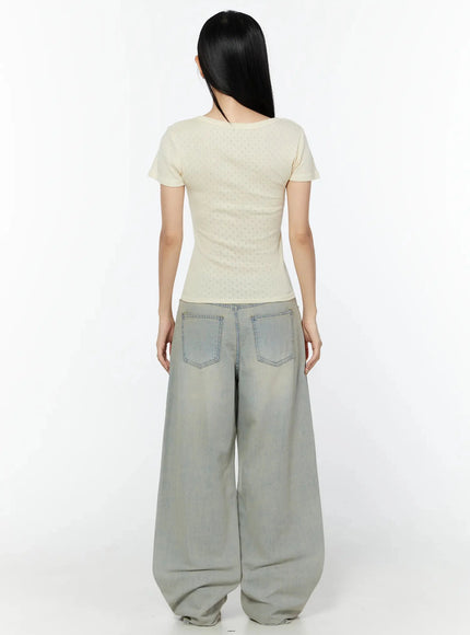 Naia Washed Baggy Jeans IU524 Light blue back full-body shot on model showing two back pockets, oversized leg volume, and subtle yellow-toned fading on denim