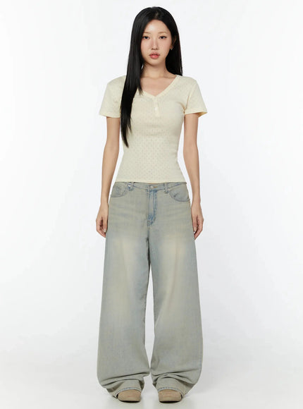Naia Washed Baggy Jeans IU524 Light blue full-body front shot on model standing straight, styled with cream textured V-neck short-sleeve top, pooling hem at sneakers