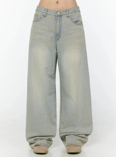 LEWKIN Naia Washed Baggy Jeans IU524 Light blue front crop shot on model showing low-rise waistband, silver button, and oversized wide-leg silhouette with vintage wash