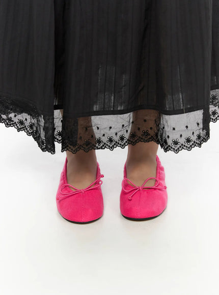 Neon Flats CL510 Pink front close-up on model standing, both shoes facing forward under black lace-trimmed skirt hem