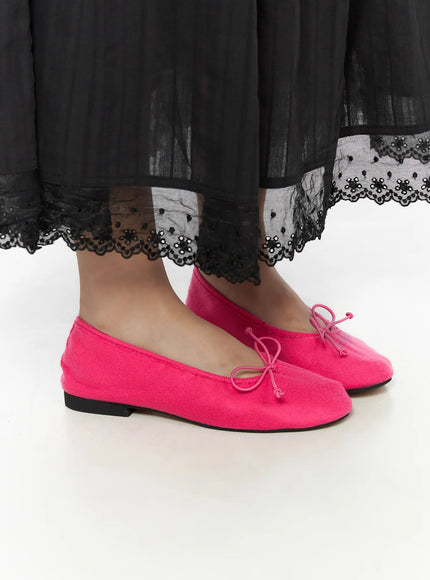 Neon Flats CL510 Pink side close-up on model, single shoe profile view showing square toe, bow tie, and flat black sole