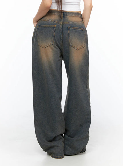 Neya Dark Washed Baggy Jeans CL517 Dark blue back shot on model waist-down showing dual back pockets brown faded wash and pooling hem at floor