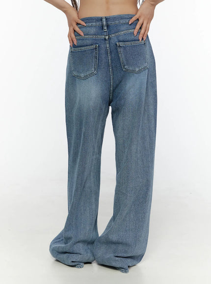 Nixi Wide Leg Jeans CL508 Blue back close-up on model with hands on waistband showing two patch back pockets and faded wide-leg denim