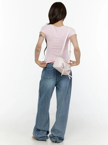 Nixi Wide Leg Jeans CL508 Blue full-body back shot on model in pink tee with cream crossbody bag showing back pockets and wide-leg hem pooling at floor