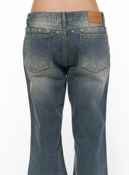 Noel Washed Bootcut Jeans CU524 Blue close-up back detail showing silver pyramid studs along waistband dual back pockets ozbridge leather label and worn wash