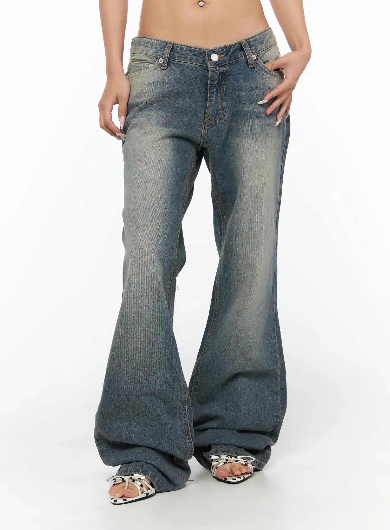Noel Washed Bootcut Jeans CU524 Blue front close-up on model with hand in pocket highlighting V low-rise waist faded wash and wide bootcut flare