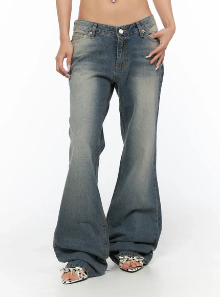 Noel Washed Bootcut Jeans CU524 Blue front close-up on model with hand in pocket highlighting V low-rise waist faded wash and wide bootcut flare