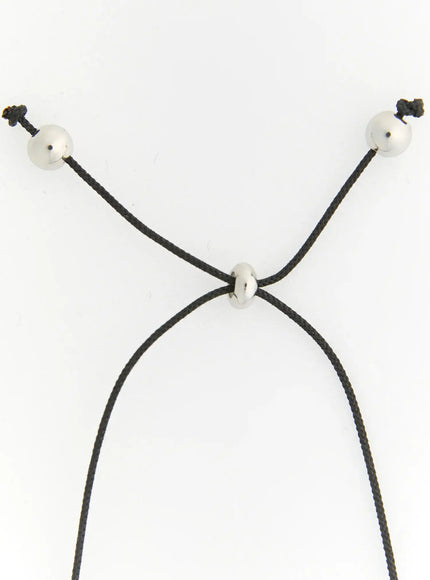 Noir Black Cord Necklace IL522 silver detail shot of adjustable black cord closure with three silver beads, white background