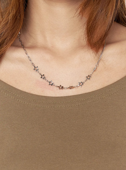 Nova Star Necklace IL517 Silver close-up on-model worn on model's neck over khaki top showing star charm placement across collarbone