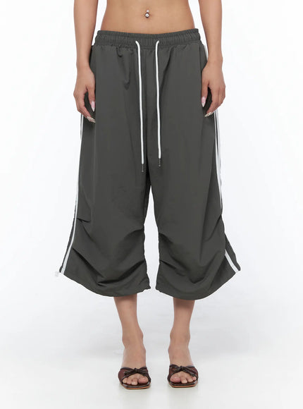 Nylon Track Bermuda Pants CU523 Dark gray front close-up on model showing wide balloon leg white drawstring waist white stripes and gathered hem