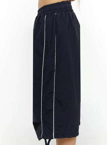 Nylon Wide-Leg Shorts IL524 Dark blue side shot on model without top showing white contrast piping along side seam and elasticated waistband detail