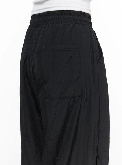 Nylon Wide Pants CL514 Black close-up back waist detail showing ruched elastic waistband and flat back patch pocket in crinkled nylon