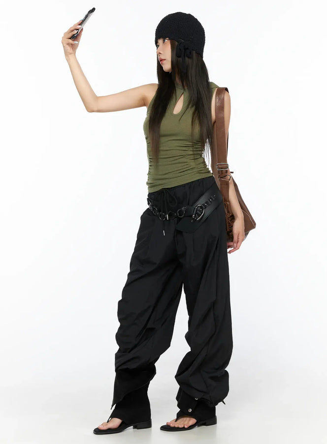Nylon Wide Pants CL514 Black full-body lifestyle shot on model taking selfie, styled with green tank belt bag and brown shoulder bag