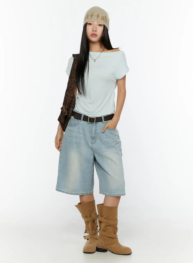 Nyra Low-Rise Jorts CU529 Light blue full-body front shot on model styled with mint off-shoulder top beanie belt and brown buckle boots