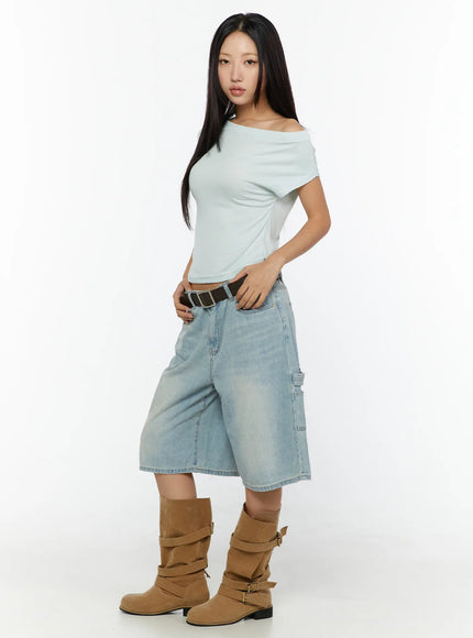 Nyra Low-Rise Jorts CU529 Light blue full-body side shot on model in mint off-shoulder top with hand on waist showing carpenter pocket and wide-leg cut