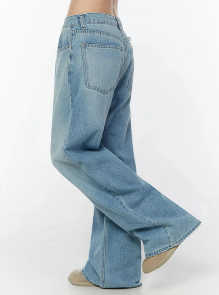 Odette Distressed Semi-Wide Jeans IU524 Blue side view close-up on model showing back pocket, wide-leg silhouette, rear seam and light blue faded denim fabric