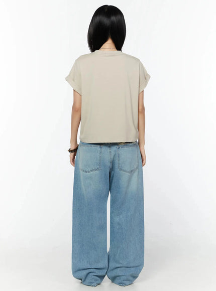 Odette Distressed Semi-Wide Jeans IU524 Blue full-body back shot on model in beige tee, showing rear pockets, wide-leg hem pooling at feet and back waistband