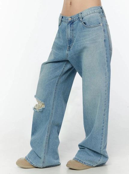Odette Distressed Semi-Wide Jeans IU524 Blue side shot on model showing left-side knee rip fraying, low-rise waist, wide-leg silhouette and light wash denim texture