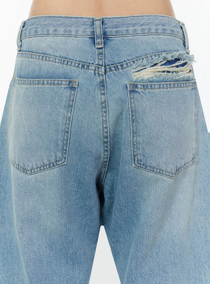 Odette Distressed Semi-Wide Jeans IU524 Blue close-up back detail shot showing frayed torn distressing above right back pocket with raw white thread texture