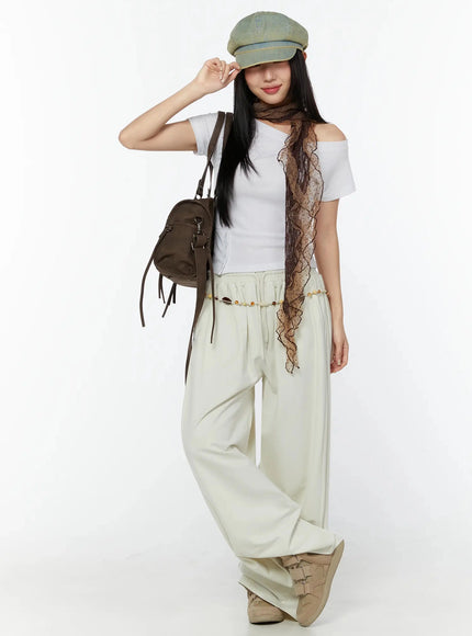 LEWKIN Off-Shoulder Buttoned Slit Tee IU524 White S/M lifestyle shot model full body wearing cap scarf bag with wide-leg cream pants