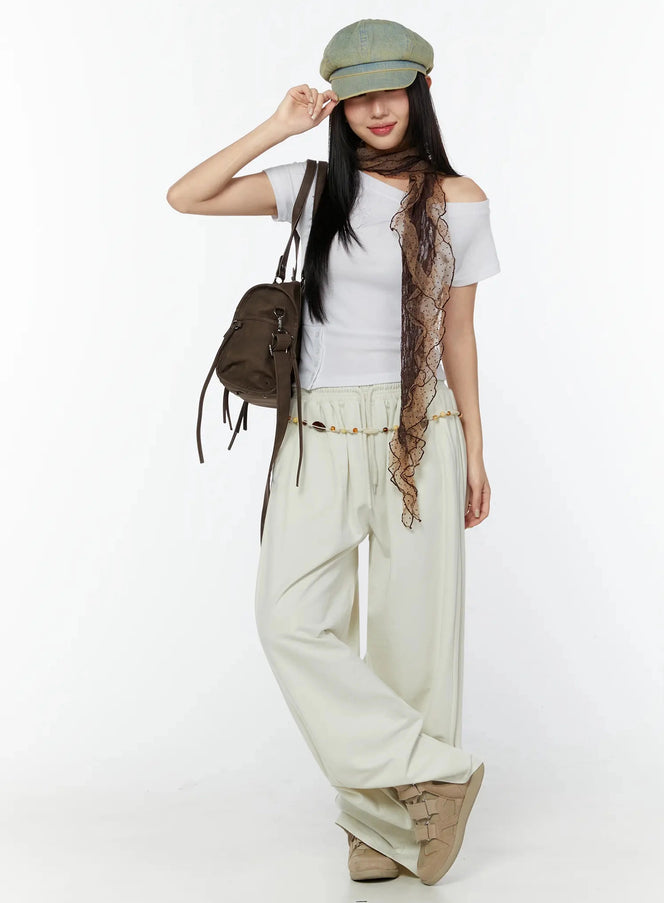 LEWKIN Off-Shoulder Buttoned Slit Tee IU524 White S/M lifestyle shot model full body wearing cap scarf bag with wide-leg cream pants
