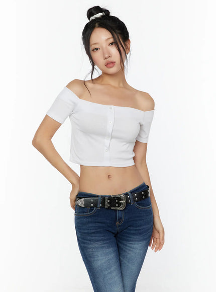 Off-Shoulder Crop Top CU529 White front model shot standing upright, ribbed knit off-shoulder crop top with silver button placket paired with blue jeans