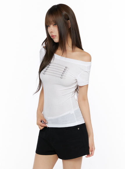 Off-Shoulder Crop Top IL523 White three-quarter side front shot on model, off-shoulder neckline with silver horizontal cord and ball buttons, slim ribbed knit fit