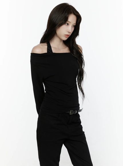 Off-Shoulder Halter Layered Top IL521 Black angled front shot on model showing solid black off-shoulder drape with dotted halter strap long sleeves fitted silhouette