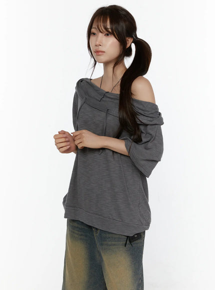 Off-Shoulder Hooded Tee CL508 Gray side shot on model, off-shoulder drape with hood down, half-sleeve and relaxed fit over jeans