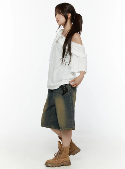 Off-Shoulder Hooded Tee CL508 White side full-body shot on model, off-shoulder silhouette with layered hood, paired with denim shorts and boots