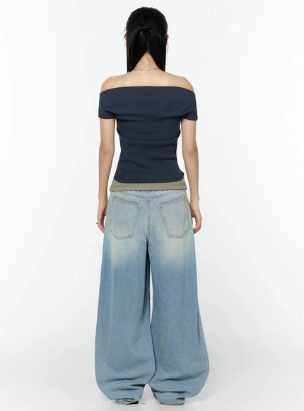 Off-Shoulder Ribbed Short Sleeve Top IU524 Dark blue back full-body model shot showing off-shoulder silhouette and ribbed back detail paired with wide-leg light-wash jeans