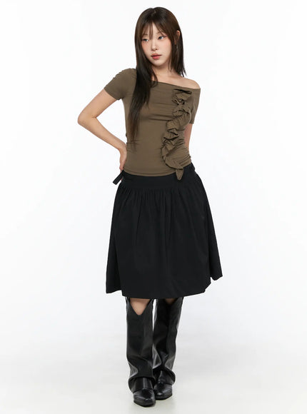 Off-Shoulder Ruffle Tee CL517 Dark beige full-body front shot on model standing upright, fitted silhouette with ruffle detail, styled with black midi skirt and tall leather boots