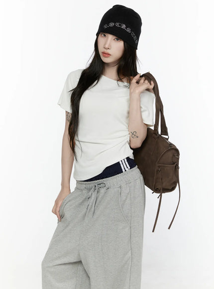 LEWKIN Off-Shoulder T-Shirt IL522 White S/M front shot on model standing with backpack, ruched side detail, cropped cotton tee