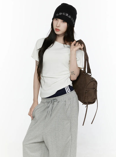 LEWKIN Off-Shoulder T-Shirt IL522 White S/M front shot on model standing with backpack, ruched side detail, cropped cotton tee