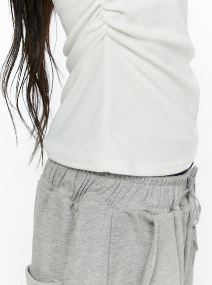 Off-Shoulder T-Shirt IL522 White detail close-up shot on model, side ruching and hem close-up showing fabric texture and cropped fit