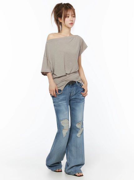 Off-Shoulder Two-Way Cami Top IU525 Beige front full-body shot on model paired with wide-leg ripped jeans showing relaxed soft jersey silhouette