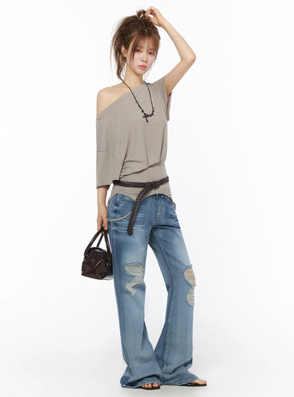 Off-Shoulder Two-Way Cami Top IU525 Beige side full-body shot on model with hand in hair holding bag styled with cross necklace and braided belt