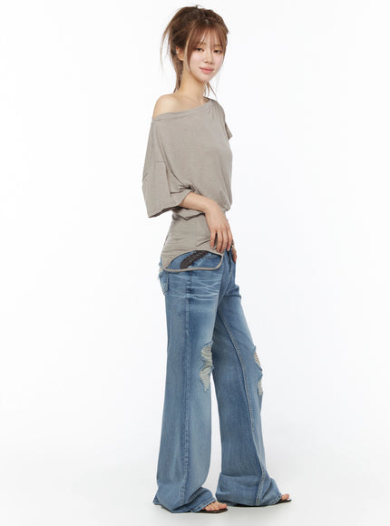 Off-Shoulder Two-Way Cami Top IU525 Beige side full-body shot on model revealing asymmetric hem curved cutout and off-shoulder drape detail