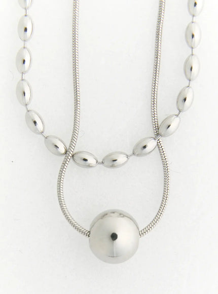 Olive Oval Necklace IL522 silver flat-lay detail showing dual-layer oval bead chain and snake chain with round ball pendant on white background