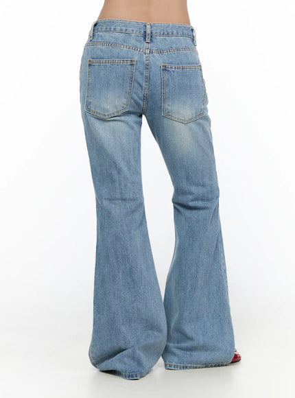 Olynn Low-Rise Distressed Flared Jeans CL513 Light blue back view close-up on model showing dual back pockets low waistband and wide flared hem in washed denim