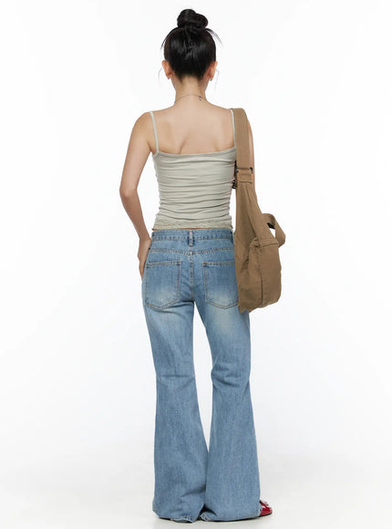 Olynn Low-Rise Distressed Flared Jeans CL513 Light blue back full-body view on model with canvas crossbody bag showing back pockets and dramatic bell-bottom flare