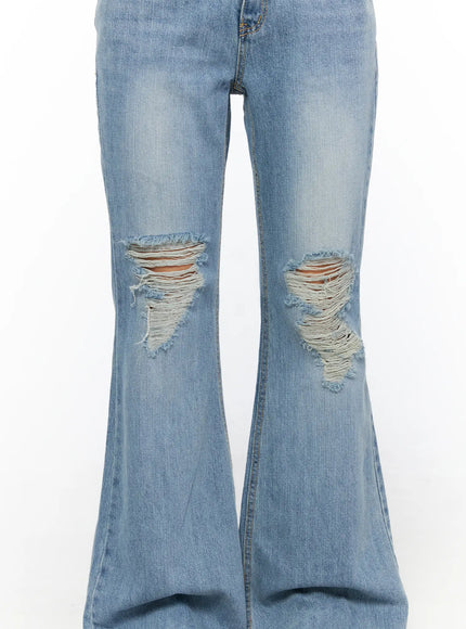 Olynn Low-Rise Distressed Flared Jeans CL513 Light blue close-up detail of both knee rips showing frayed distressed threads on flared denim legs