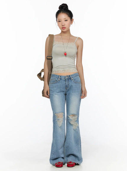 Olynn Low-Rise Distressed Flared Jeans CL513 Light blue full-body front shot on model styled with lace cami top and canvas crossbody bag with strawberry necklace