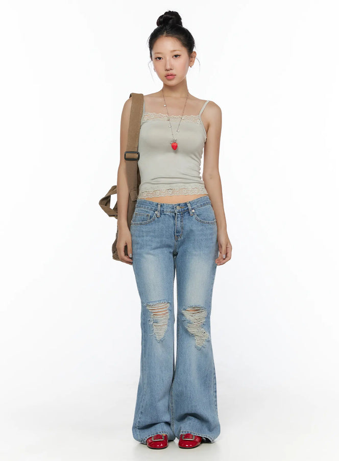 Olynn Low-Rise Distressed Flared Jeans CL513 Light blue full-body front shot on model styled with lace cami top and canvas crossbody bag with strawberry necklace