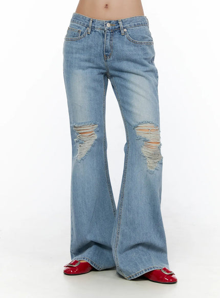 Olynn Low-Rise Distressed Flared Jeans CL513 Light blue front view on model waist-down showing low-rise fit large knee rips frayed threads and wide flared legs