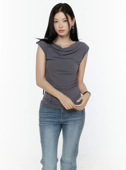 One Shoulder Ribbon Shirred Sleeveless Top IL506 Grey front shot on model with hands clasped, cowl neck and shoulder ribbon tie, paired with blue jeans
