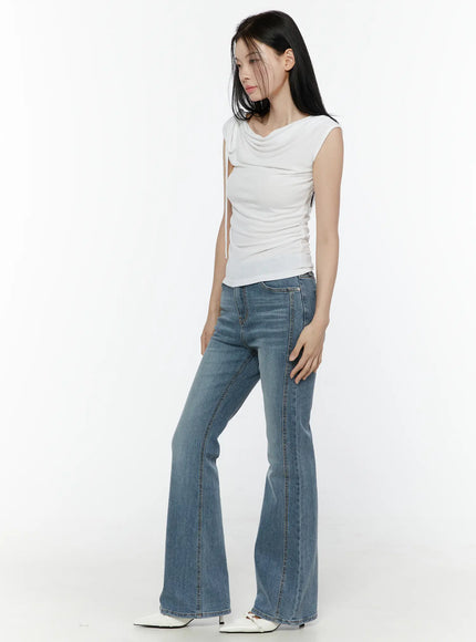 One Shoulder Ribbon Shirred Sleeveless Top IL506 White side full-body shot on model looking down, showing ruched side and back silhouette with flare jeans