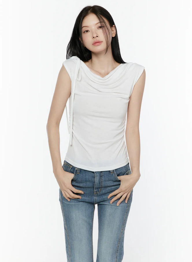 LEWKIN One Shoulder Ribbon Shirred Sleeveless Top IL506 White front shot on model wearing jeans, hands in pockets, cowl neck with shoulder ribbon tie