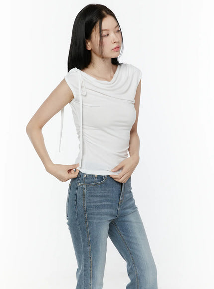 One Shoulder Ribbon Shirred Sleeveless Top IL506 White side angle three-quarter shot on model with hand on hip showing ruched side and cowl drape