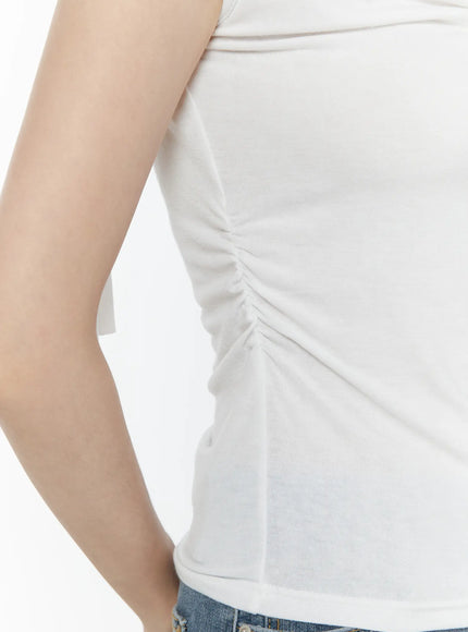 One Shoulder Ribbon Shirred Sleeveless Top IL506 White close-up side detail of gathered ruching at hem and stretchy soft jersey fabric texture on model